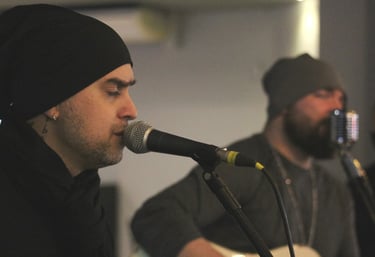 a man with a beard and a beard playing guitar