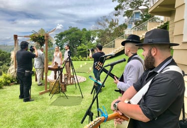 a man in a hat and a guitar playing a song