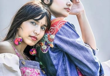 two women sitting on a bench in a park