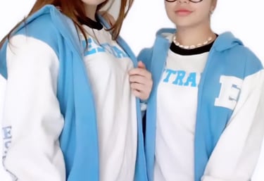 two women in blue jackets and glasses posing for a photo