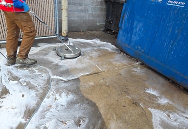 actively cleaning a dumpster enclosure