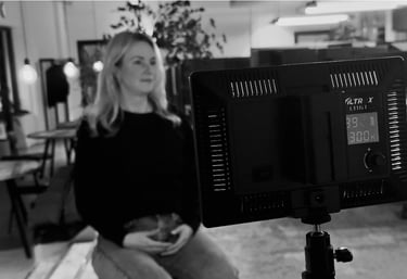 a woman sitting on a chair in a room while being interviewd