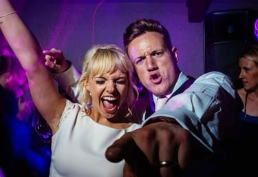 a man and woman dancing at a party