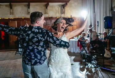 Bride dances with guest during South Wales wedding reception, captured in energetic candid style by photographer Owen Mathias