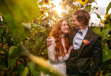 a man and woman standing in front of a sunflower