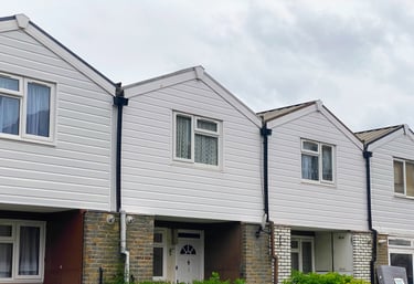 A hous with white panel top floor and double galzing window