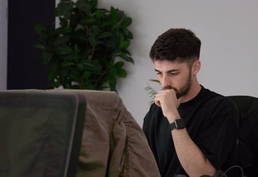 a man sitting at a desk with a laptop computer