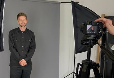 a man in a black shirt and a camera