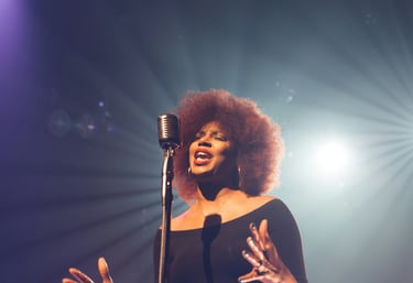 a woman in a black dress and a microphone