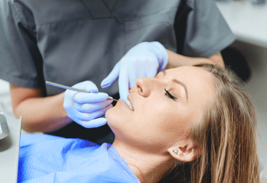 woman having her teeth examined by her dentist