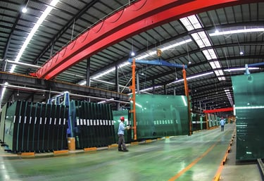 a man standing in a warehouse with a crane