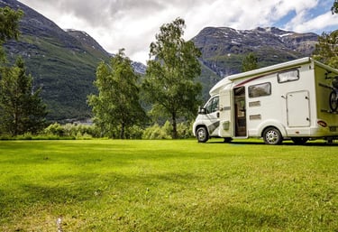 a camper van parked in a grassy field