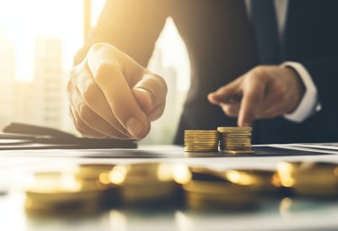 investment manager with gold coins and investing papers