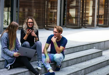 group of young millennials chatting in group on stairs representing gold ira for millennials