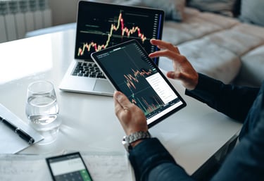 person with interactive investing chart and a calculator