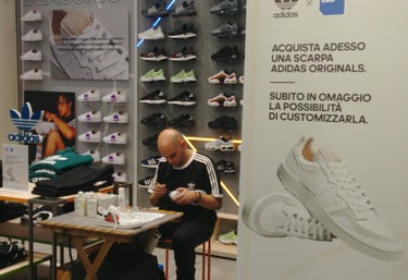 a man sitting at a table customizing shoes