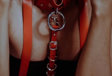 A subservient woman with a red collar bending over