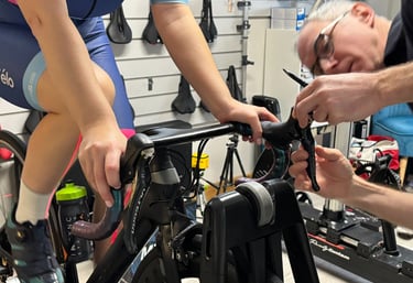 Close-up of a bike fitter adjusting a customer's bike