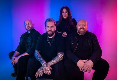 a group of people sitting on a bench in front of a colorful background