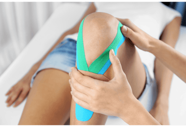 A knee with some bright tape used for support.