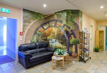 a living room with a couch and a wall mural