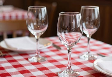 Cozy bistro interior with wooden tables set for a friendly lunch gathering.