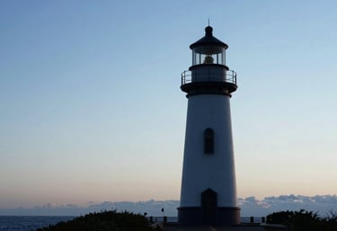 A bright and clear image of a lighthouse silhouette at dawn, symbolizing guidance and hope, incorporating #3D5A7F and #F5F8FA.
