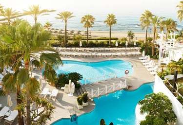 a pool with a view of the ocean and a couple of people