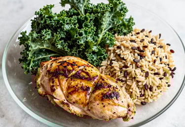 A woman with curly hair is performing a workout with a kettlebell in a gym environment. She is wearing a striped shirt, black leggings, and white sneakers. The gym is equipped with weights, benches, and other fitness equipment.