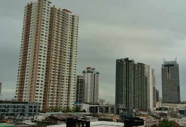 a city skyline with tall buildings and a clock tower