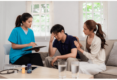 a nurse in a living room with a couple