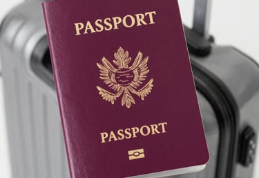 Various travel-related items are laid out on a map. The objects include a small model of the Eiffel Tower, a vintage camera, a modern instant camera, a notebook with a sketch of an architectural landmark, and a pencil. The map shows detailed streets and locations, likely from a city in Europe.