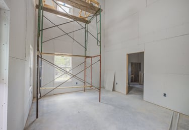 Unfinished primary bedroom with scaffolding during construction of Wimberley home