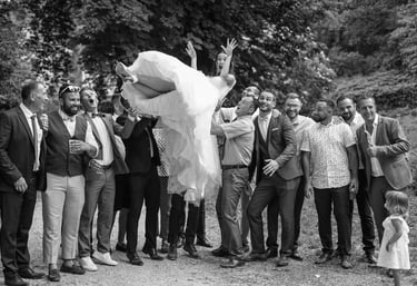 black and white picture of men throwing the bride in the air during a wedding in dijon