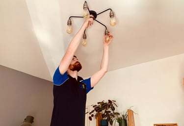 GigaVolt electrician installing a decorative light fitting
