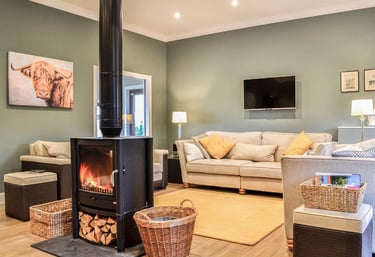 Comfortable lounge with logburner and sofas