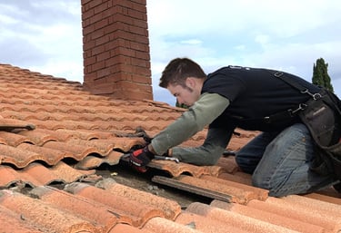 Working on a roof replacing tiles