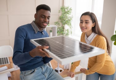 a man and woman holding a solar paneled solar panel