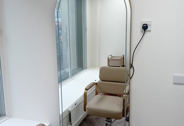 a chair with a mirror and a mirror in the background