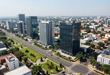 A high-angle view of a well-planned commercial district in Gurgaon, showing modern roads and landscaped green areas surrounding professional office towers under a bright midday sun.