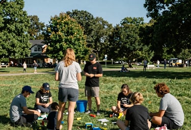 A community wellness day in a Michigan park. Families are engaged in educational activities under a bright, clear sky. Trusted and supportive mood.