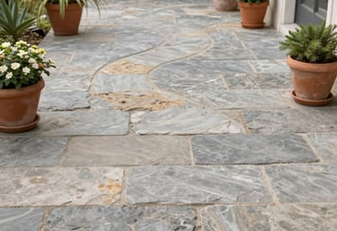 An outdoor bathroom featuring natural stone and elegant fixtures under open sky.