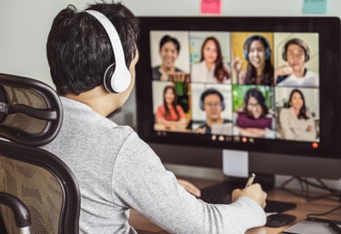 a man in headphones and headphones is sitting at a computer