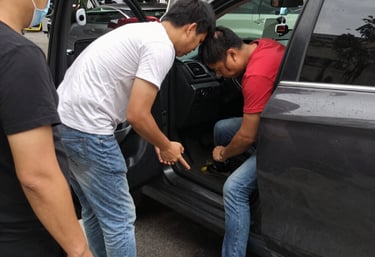Close-up of a technician repairing a car key fob with precision tools.