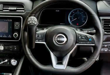 A Nissan steering wheel featuring an integrated remote control accessibility aid for disabled drivers.