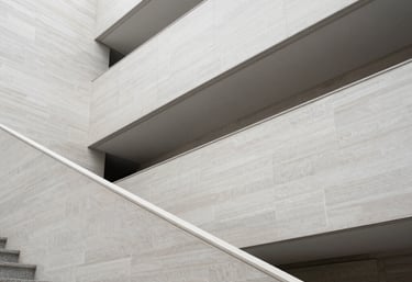 Abstract photography of modern architectural lines in an international museum setting. Light grey and off-white textures with high-key lighting.