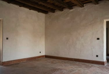 A finished interior room in a Spanish / Latin American house showcasing smooth Durlock walls and professional lighting.