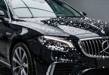 Close-up of sparkling clean shop windows reflecting a blue sky.