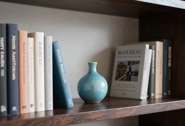 A small turquoise ceramic vase sits on a dark wooden bookshelf surrounded by hardcover books.