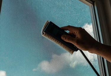 A close-up of a perfectly clean window screen against a bright teal Florida sky, demonstrating the attention to detail in track and screen cleaning.